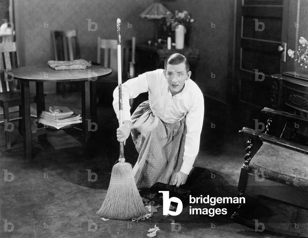 Man Cleaning up with a Broom