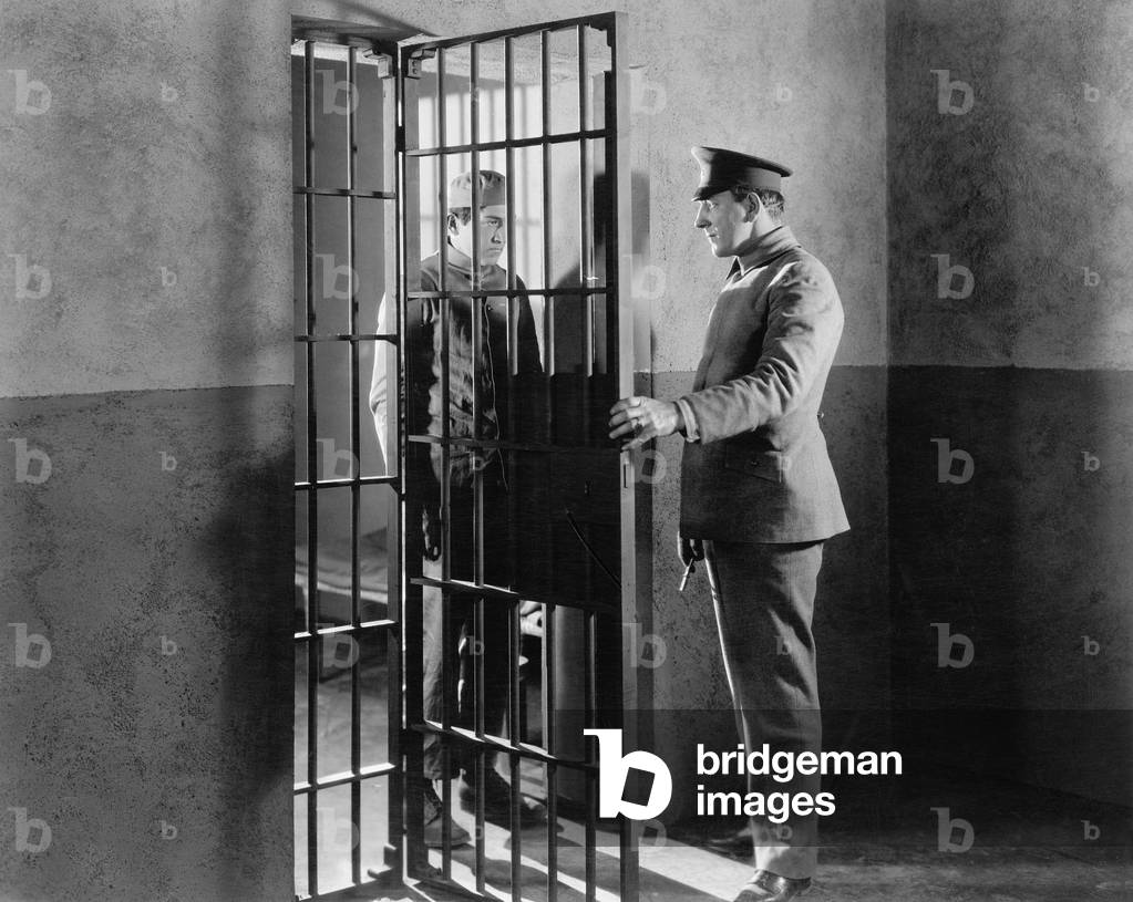 Policeman and Prisoner in a Jail Cell