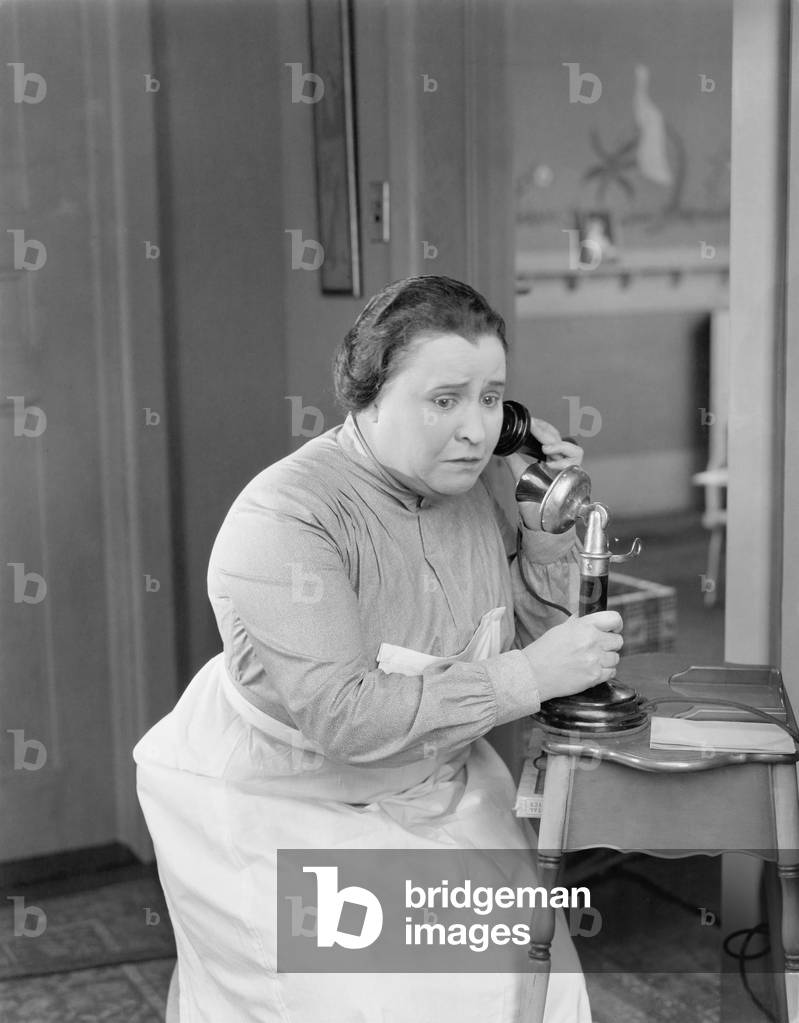 Worried Woman Using Telephone