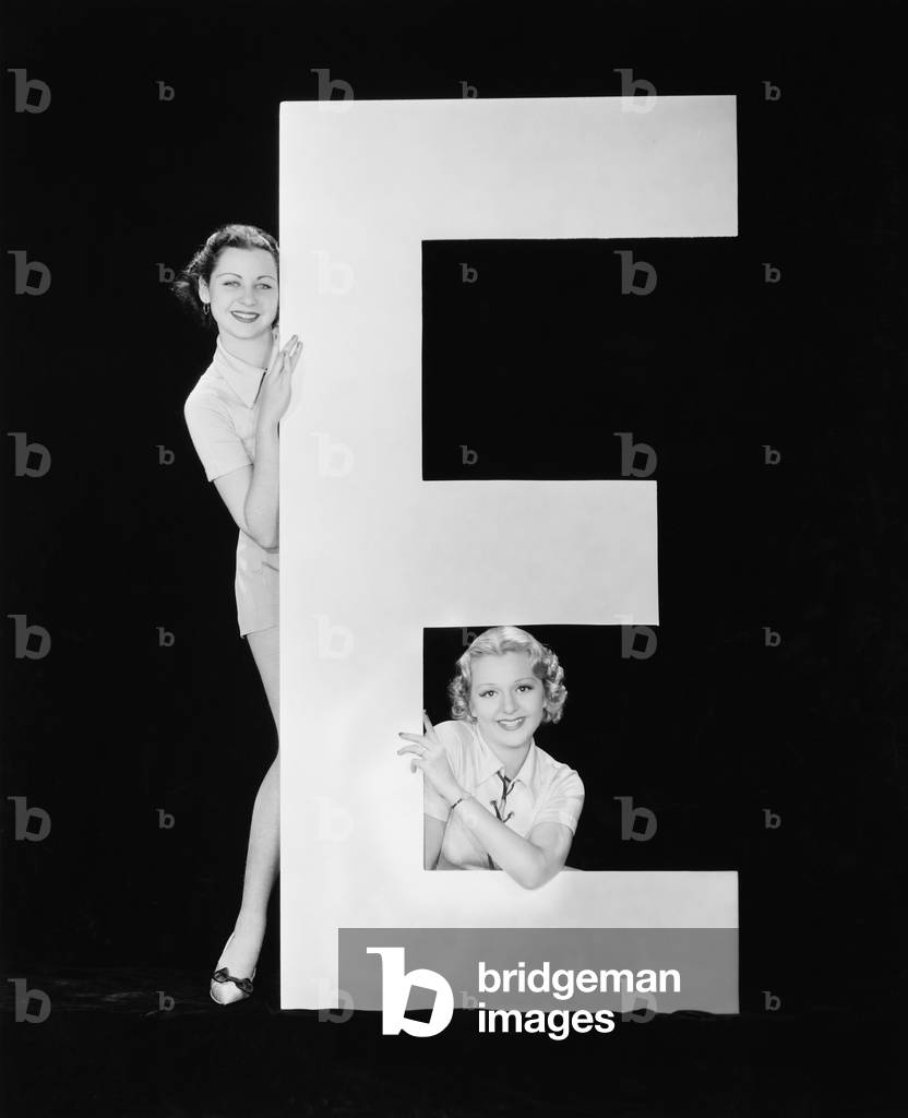 Women Posing with Huge Letter E