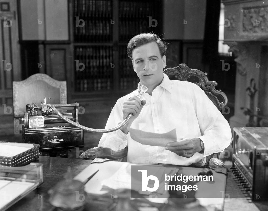 Man Reading Into Dictaphone