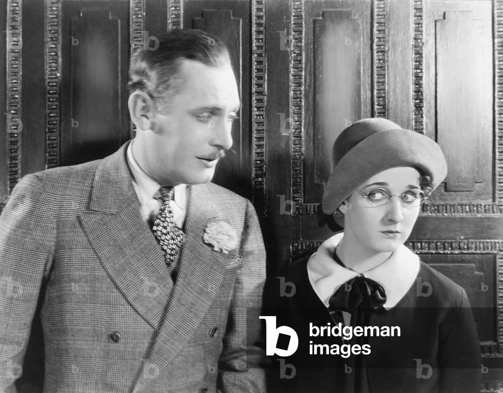 Woman Looking Shyly at a Man Next to Her