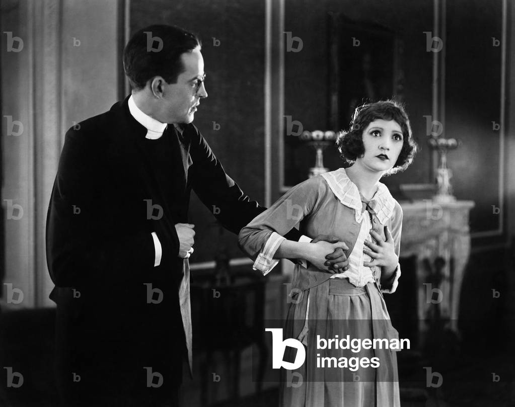 Young Woman Holding a Man's Hand and Looking Surprised