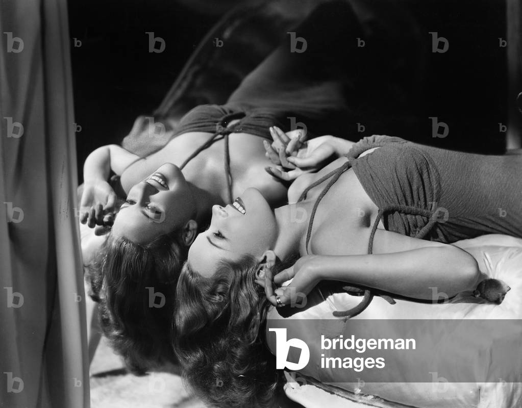 Woman Lying on her Back Next to Mirror
