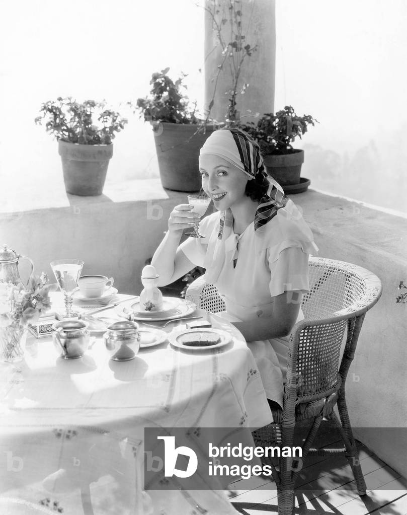 Woman Sitting on a Verandah Having Breakfast