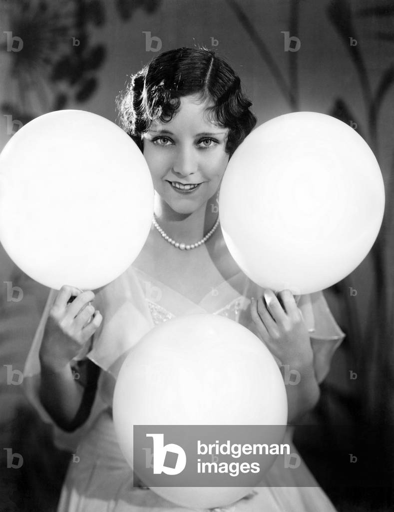 Portrait of a Young Woman Balancing Balloons on her Hands and Knees