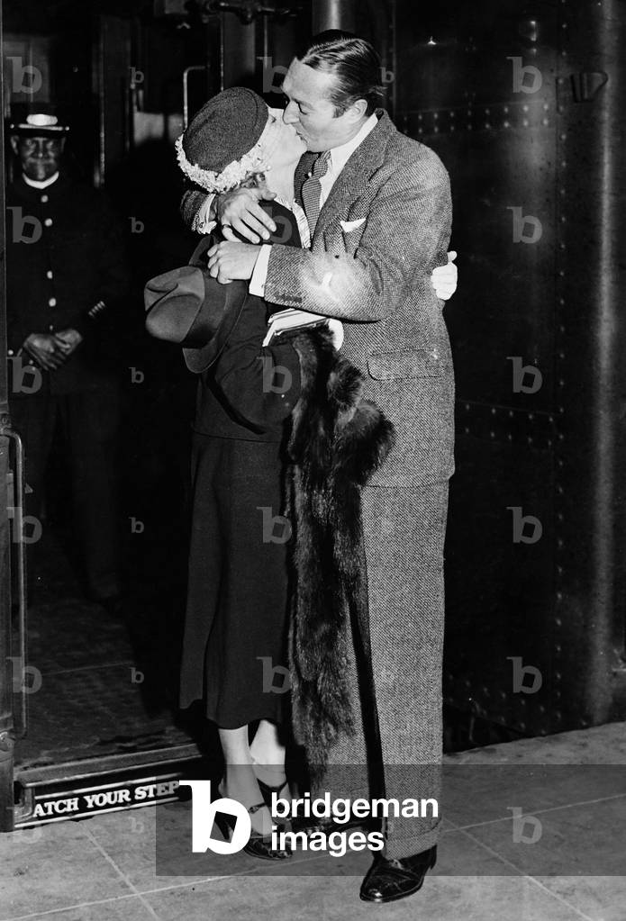 Couple Kissing Each Other at a Railroad Station Platform
