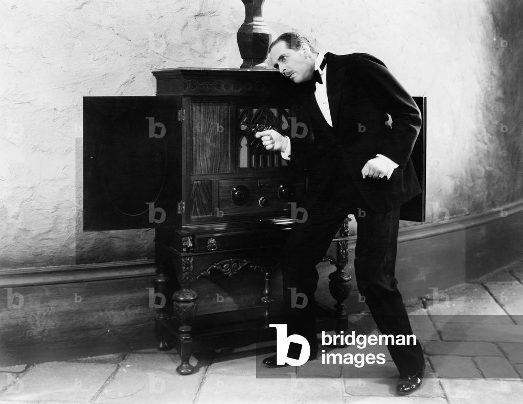 Man Listening and Dancing to Music From a Radio