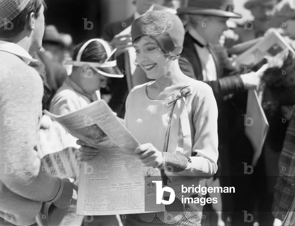 Elegant Woman Reading a Newspaper