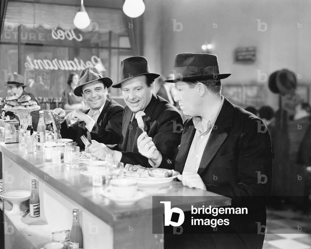 Three Men Sitting at the Counter of a Diner