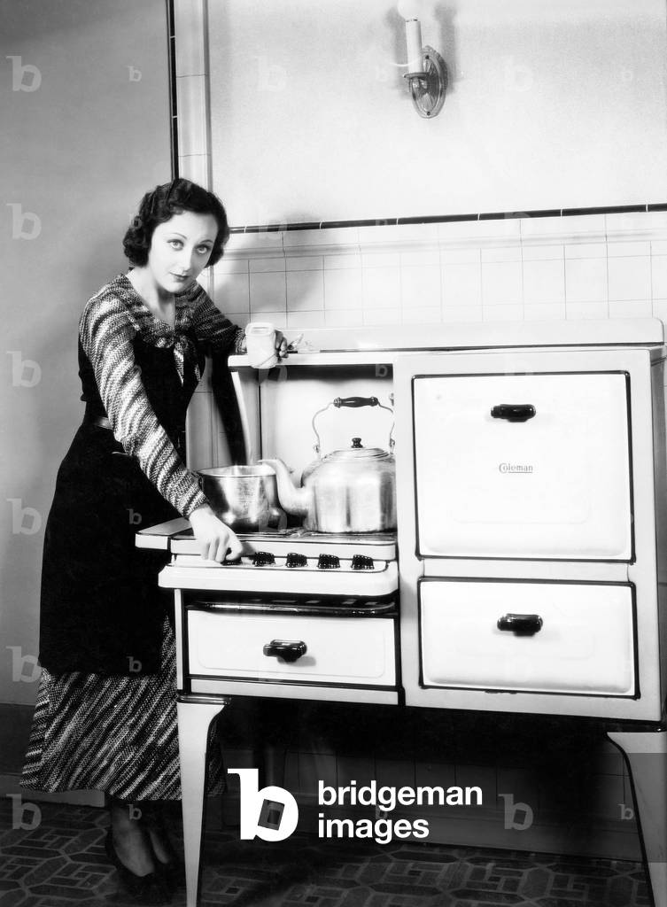 Woman Next to her Stove in the Kitchen