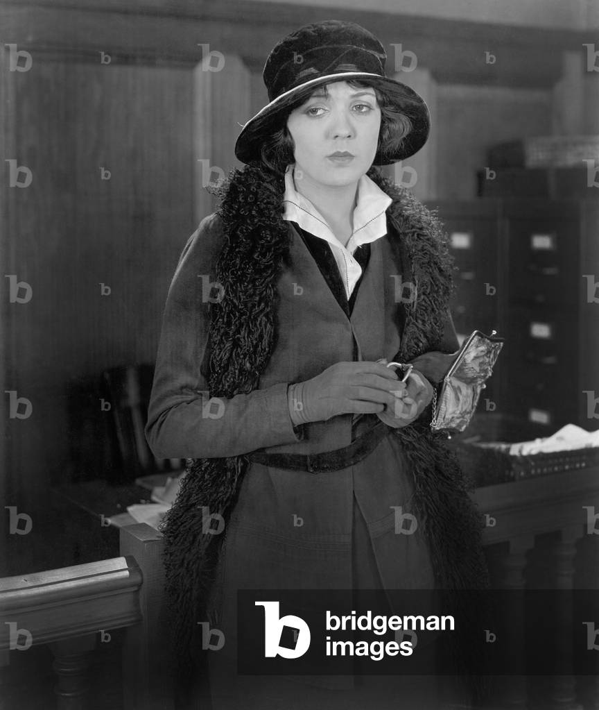 Woman Holding her Empty Wallet Looking Very Sad