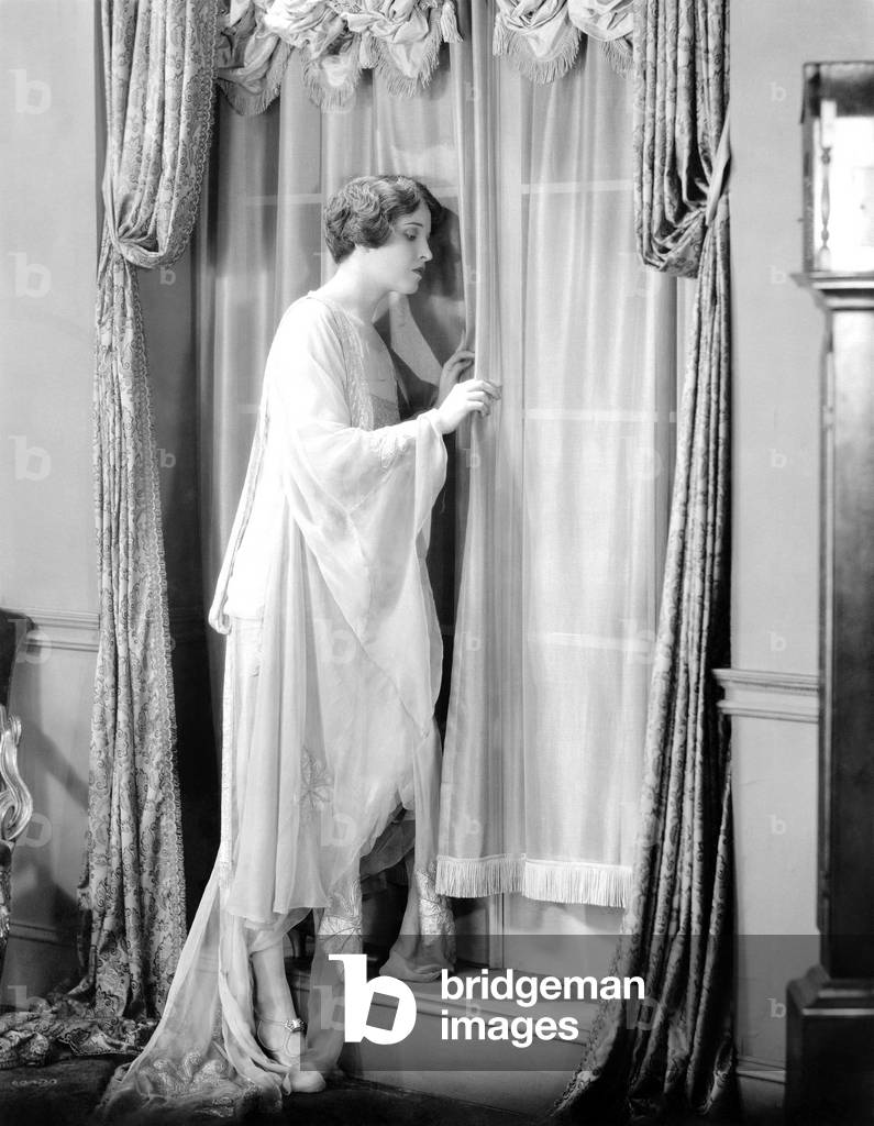 Woman Peeking Out Window