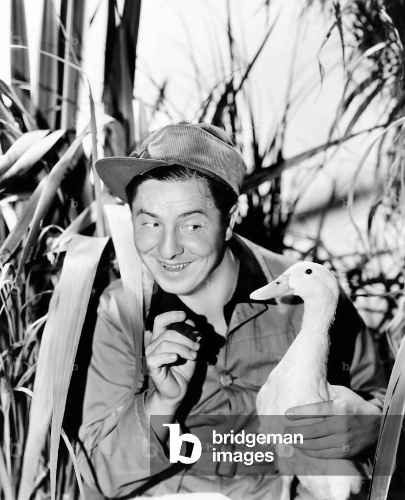Young Smiling Man Holding a Duck