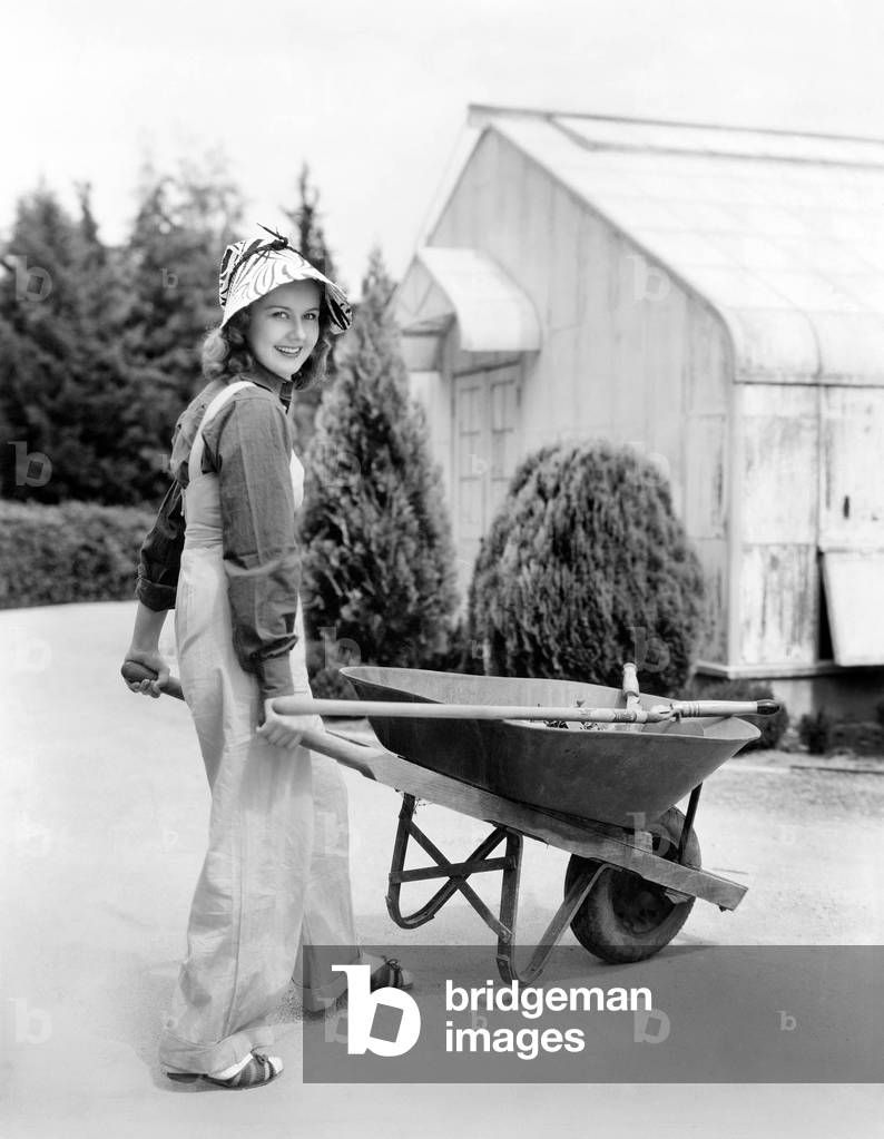 Woman Walking with a Wheel Barrel