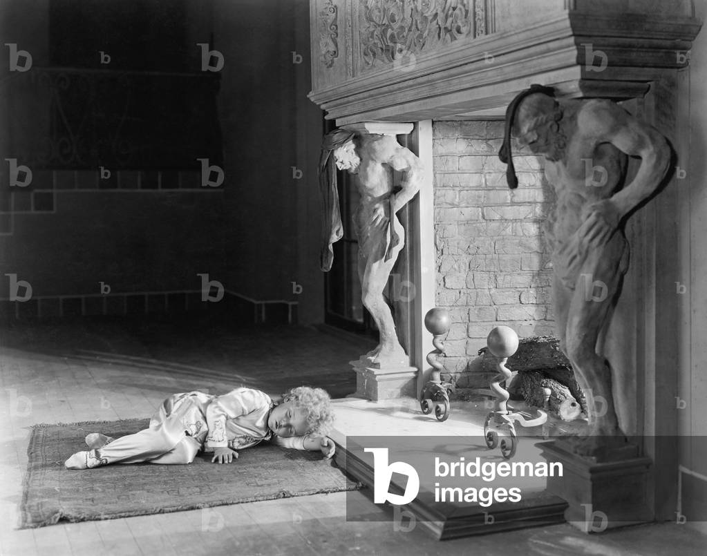 Little Girl Sleeping in Front of a Fireplace
