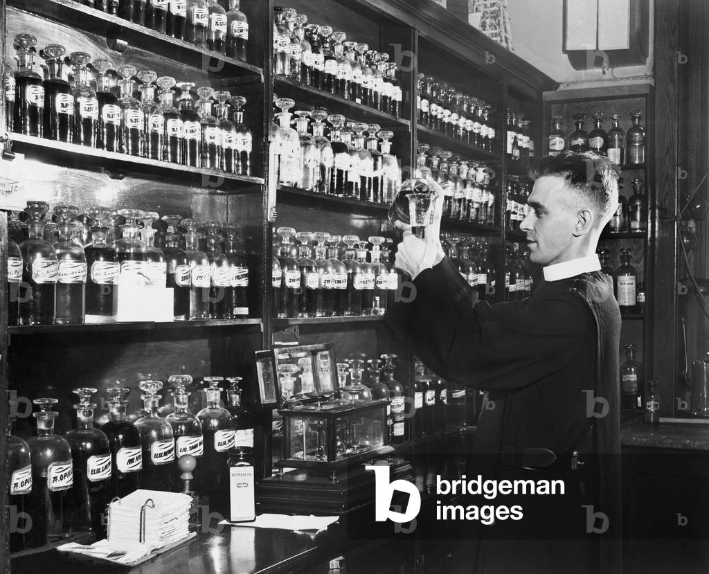 Man in a Pharmacy Mixing Medicine