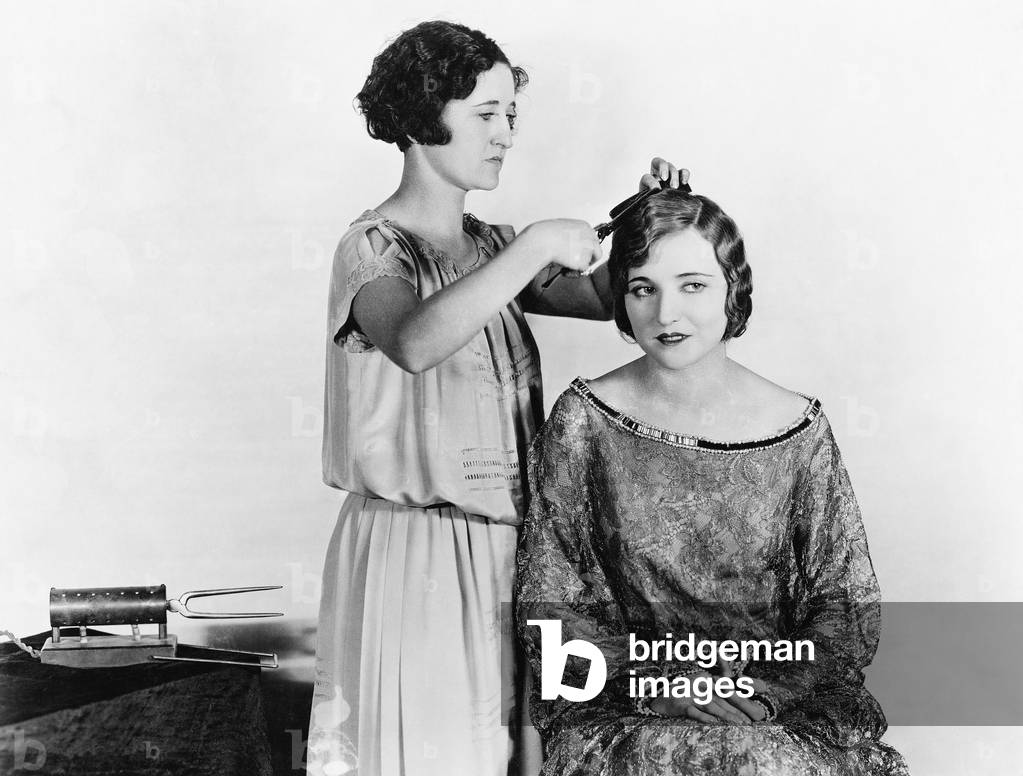 One woman doing another woman's hair (EV006537_H)