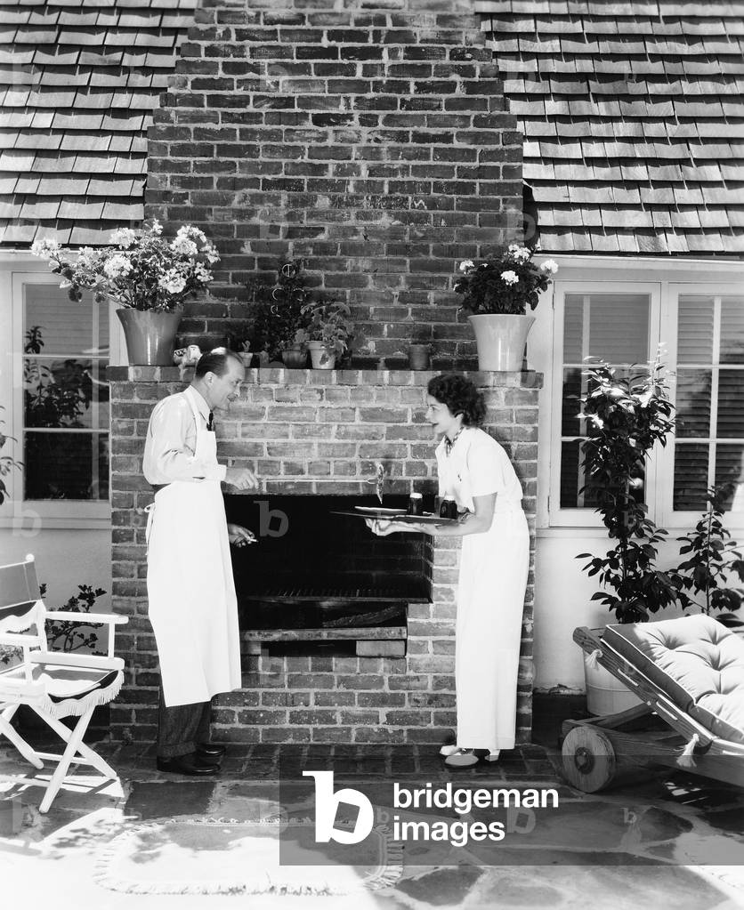 Man in Woman at Their Barbecue in the Back Yard