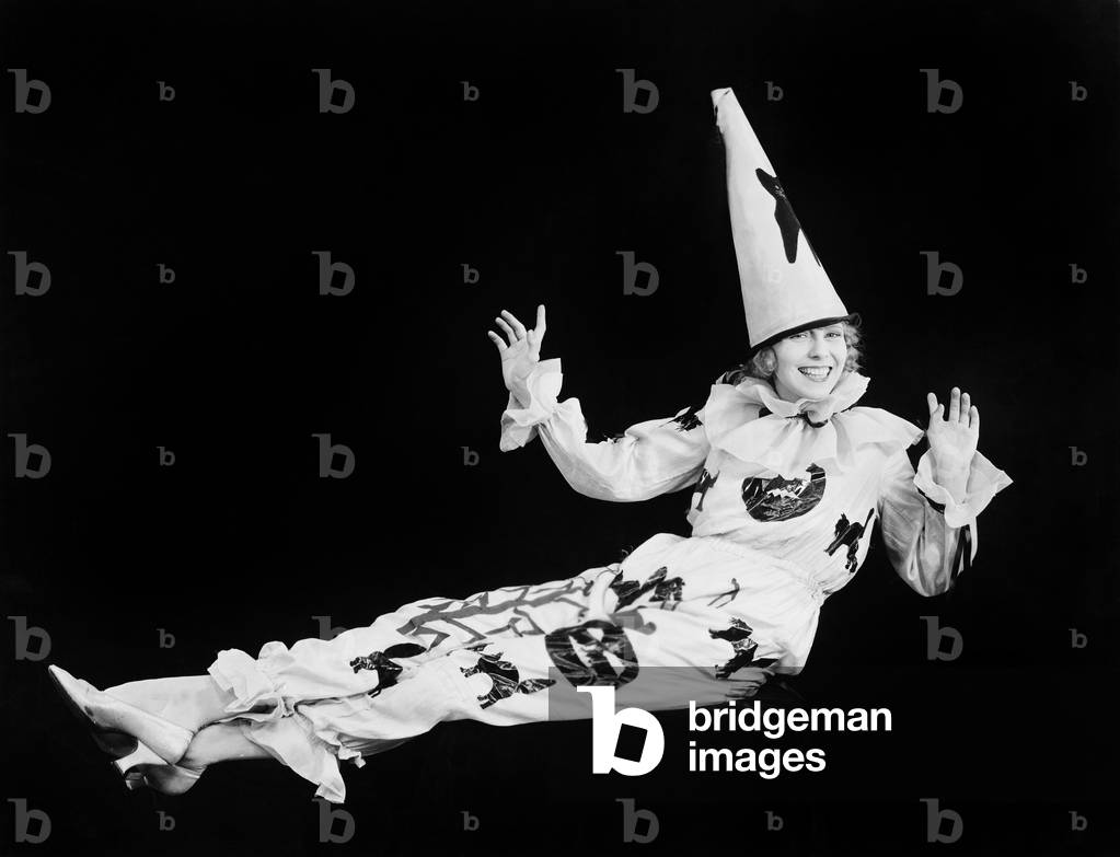 Portrait of a Clown Smiling with her Arms Raised
