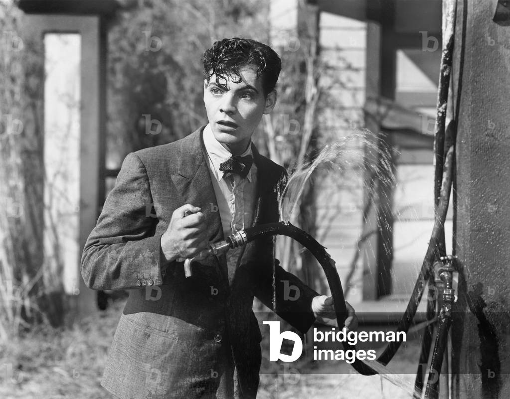 Man Getting All Wet From a Broken Hose