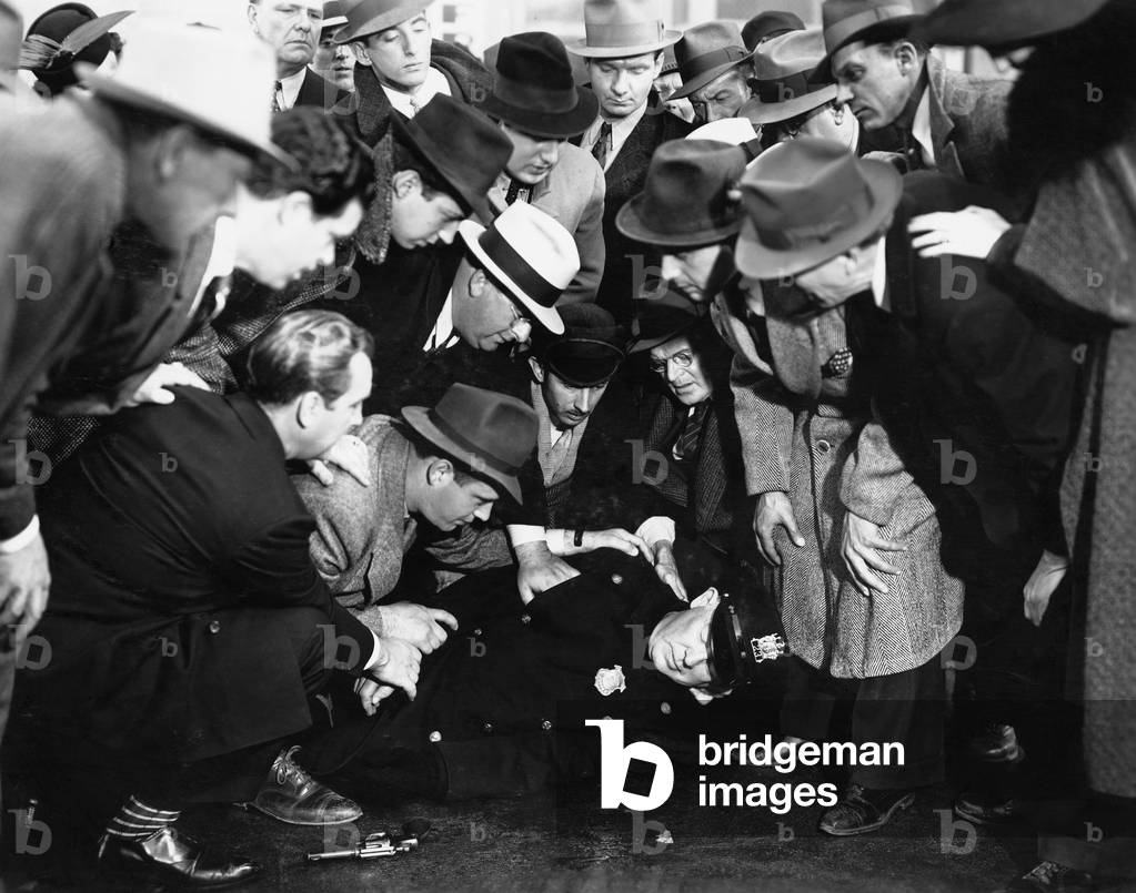 Crowd Reviving Police Officer