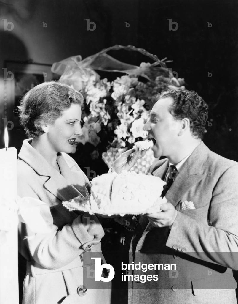 Woman Feeding a Man a Piece of Cake