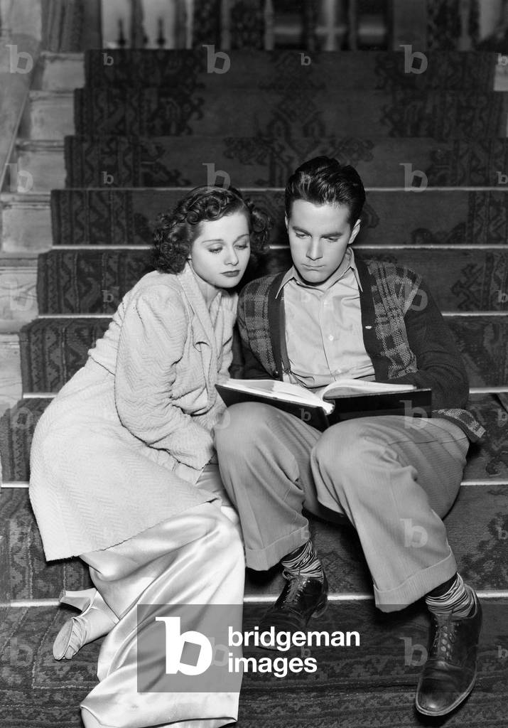Couple Reading Together on Stairs