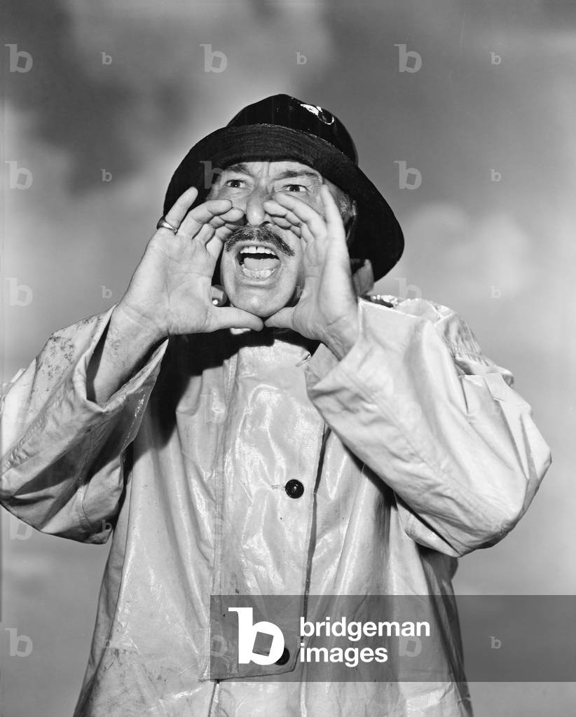 Portrait of Man in Raincoat Yelling