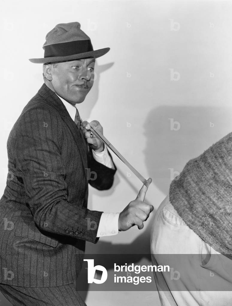 Man Snapping Rear End with Rubber Band