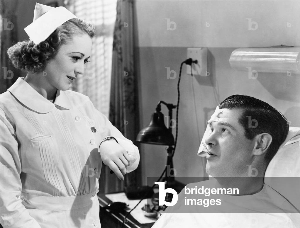 Nurse Taking Patients Temperature