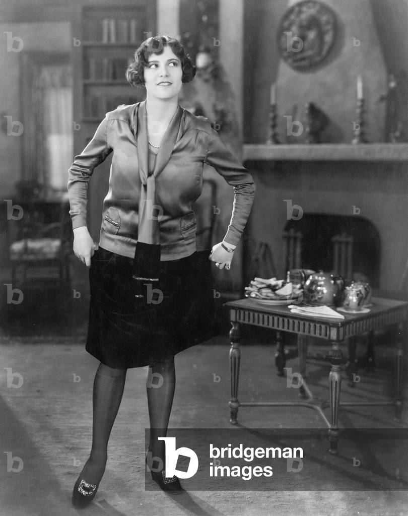 Young Woman Standing in a Living Room
