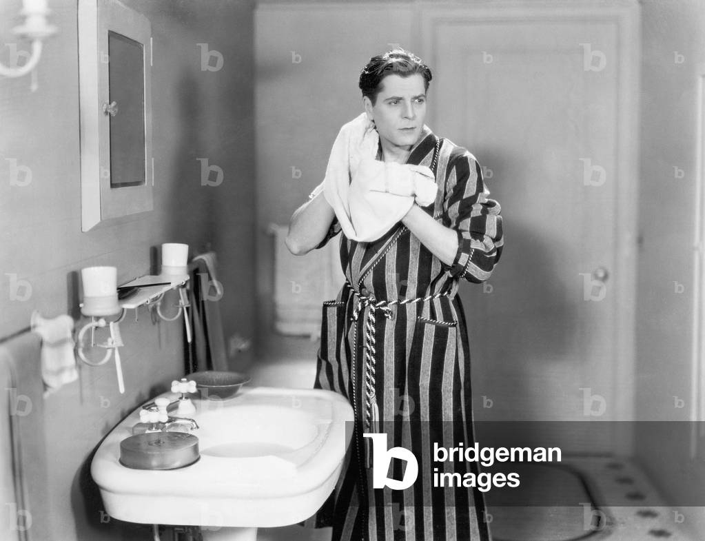 Man in the Bathroom Drying his Neck