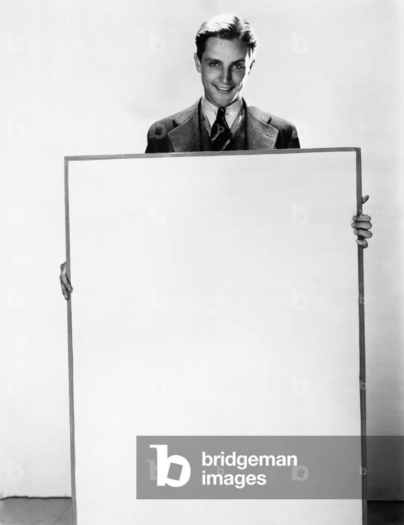 Portrait of a Businessman Holding a Poster and Smiling