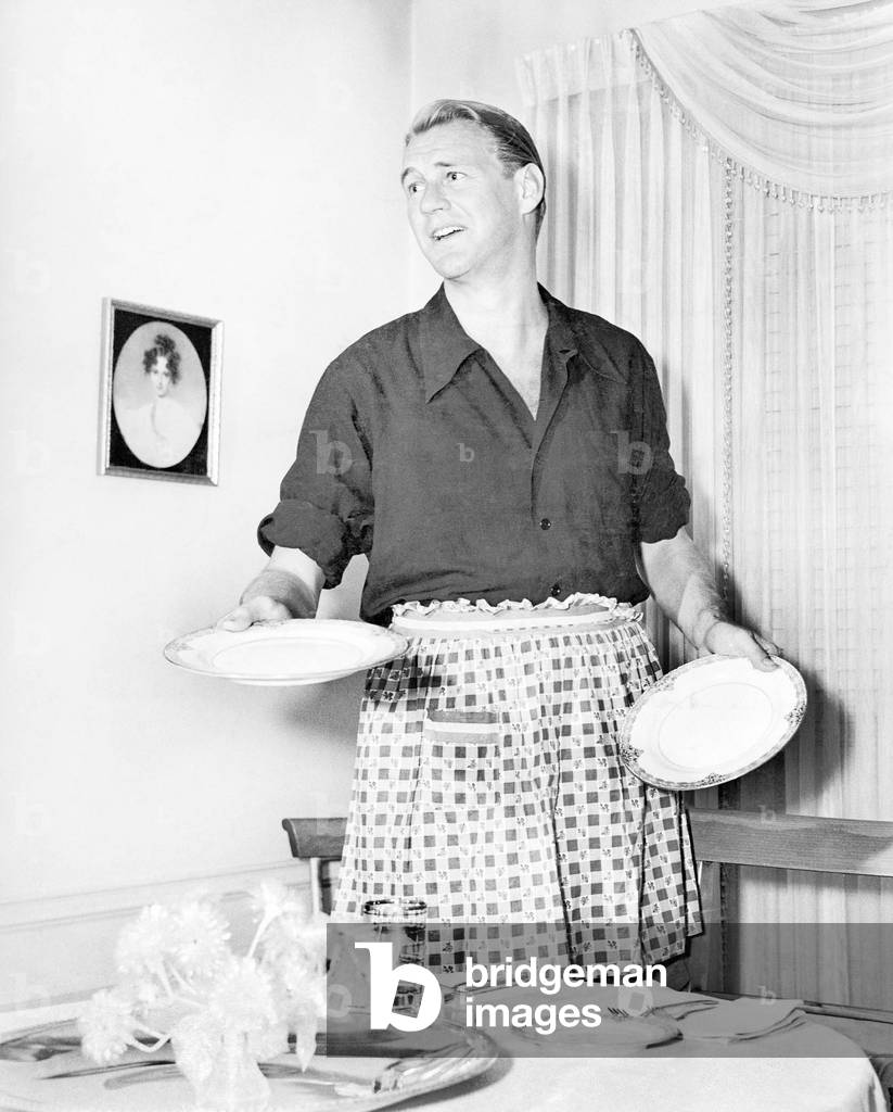 Man in an Apron Setting the Table