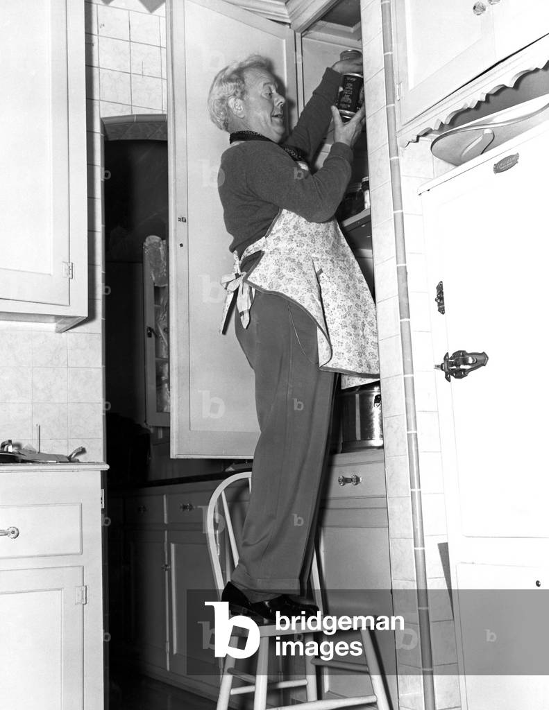Man Wearing Apron in Kitchen