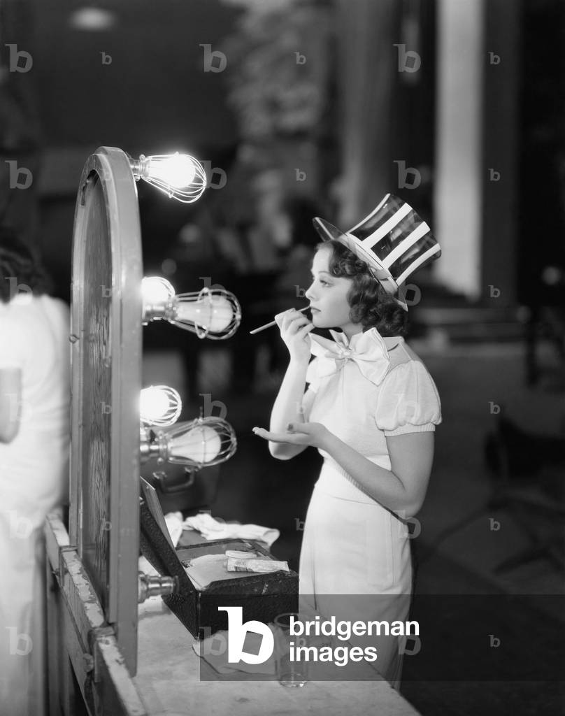 Woman in Costume Applying Makeup