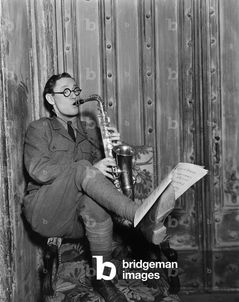 Saxophone Player Reading Music on Foot