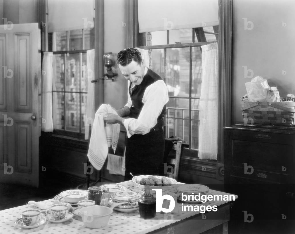 Man Standing in the Kitchen Cooking a Meal