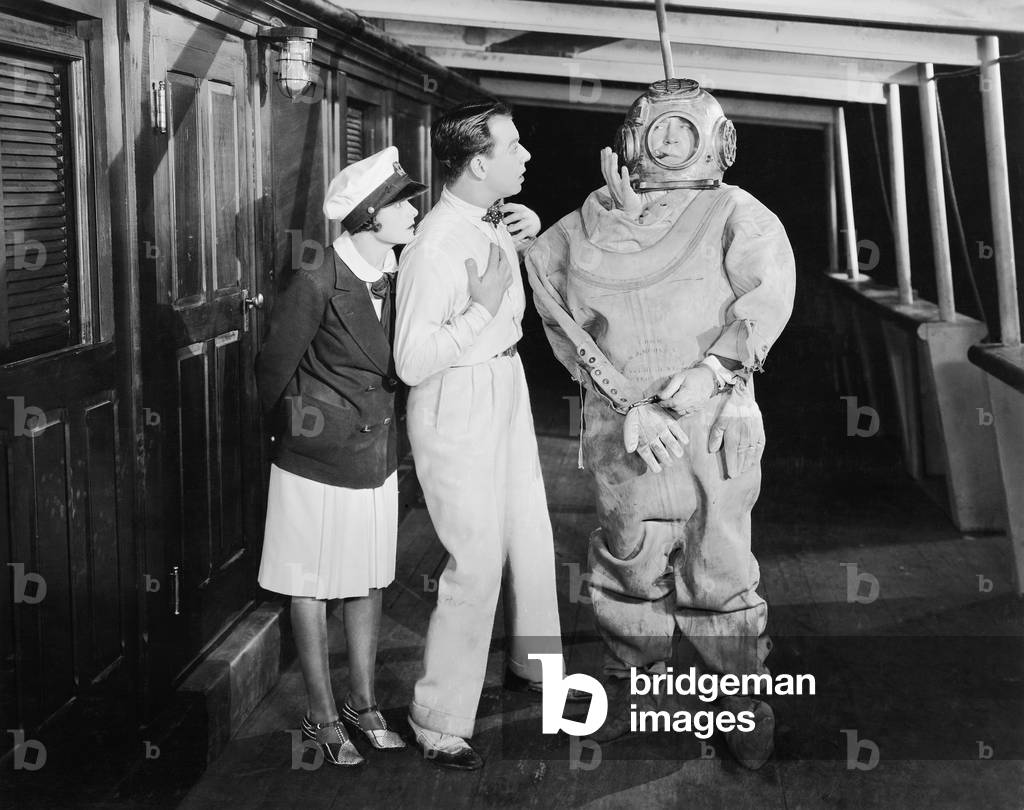 Two People Looking in Shock at a Diver in a Divers Suit