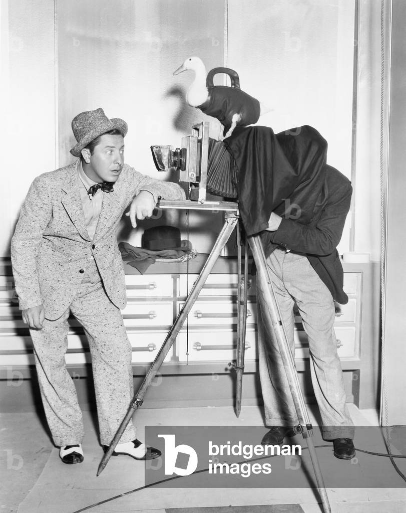 Photographer Taking a Picture of a Young Man