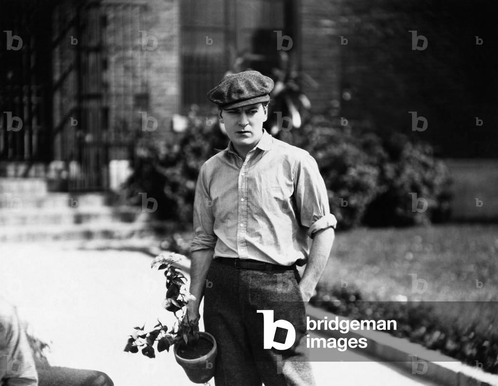 Young Man Holding a Potted Plant
