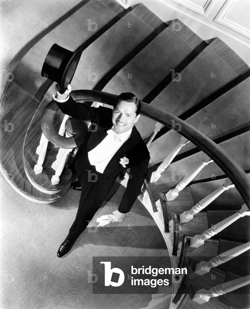 Elegant Man Looking up From the Bottom of a Staircase
