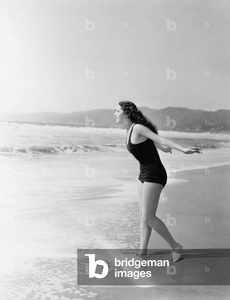 Woman Running Into the Water at the Beach