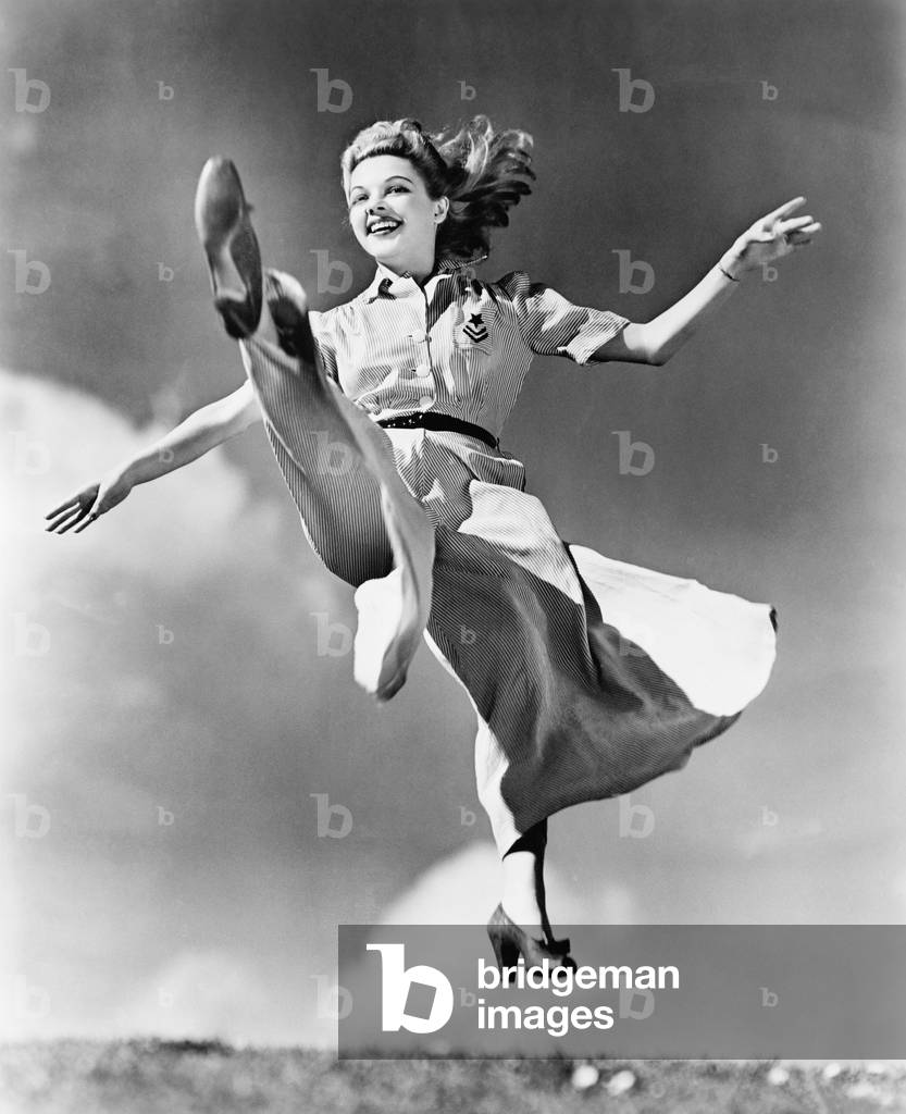 Woman in a Flowing Dress Leaping Through the Air