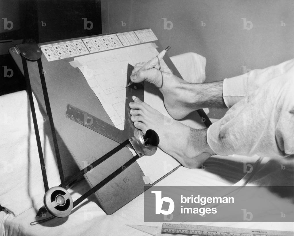 Feet of a Disabled Man Using a Drafting Board