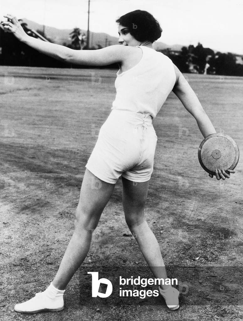 Rear View of a Young Woman Throwing a Discus