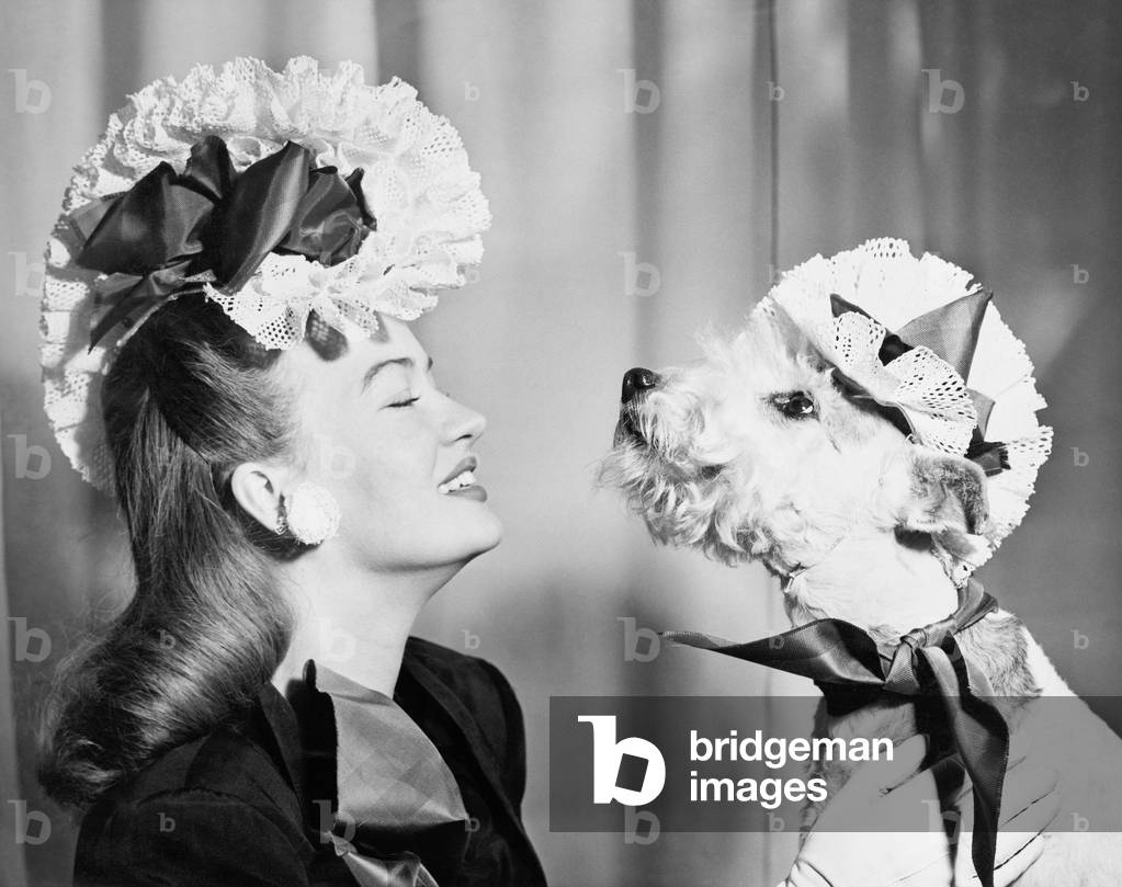 Young Woman with her Dog Who is Wearing the Same Hat