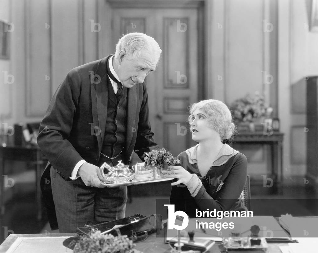 Older Man Serving a Woman Tea on a Tray