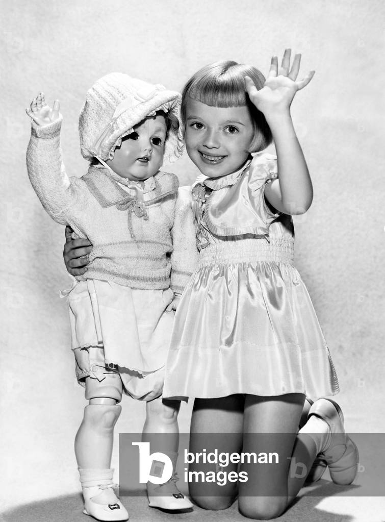 Portrait of a Girl Kneeling and Holding her Lifesize Doll